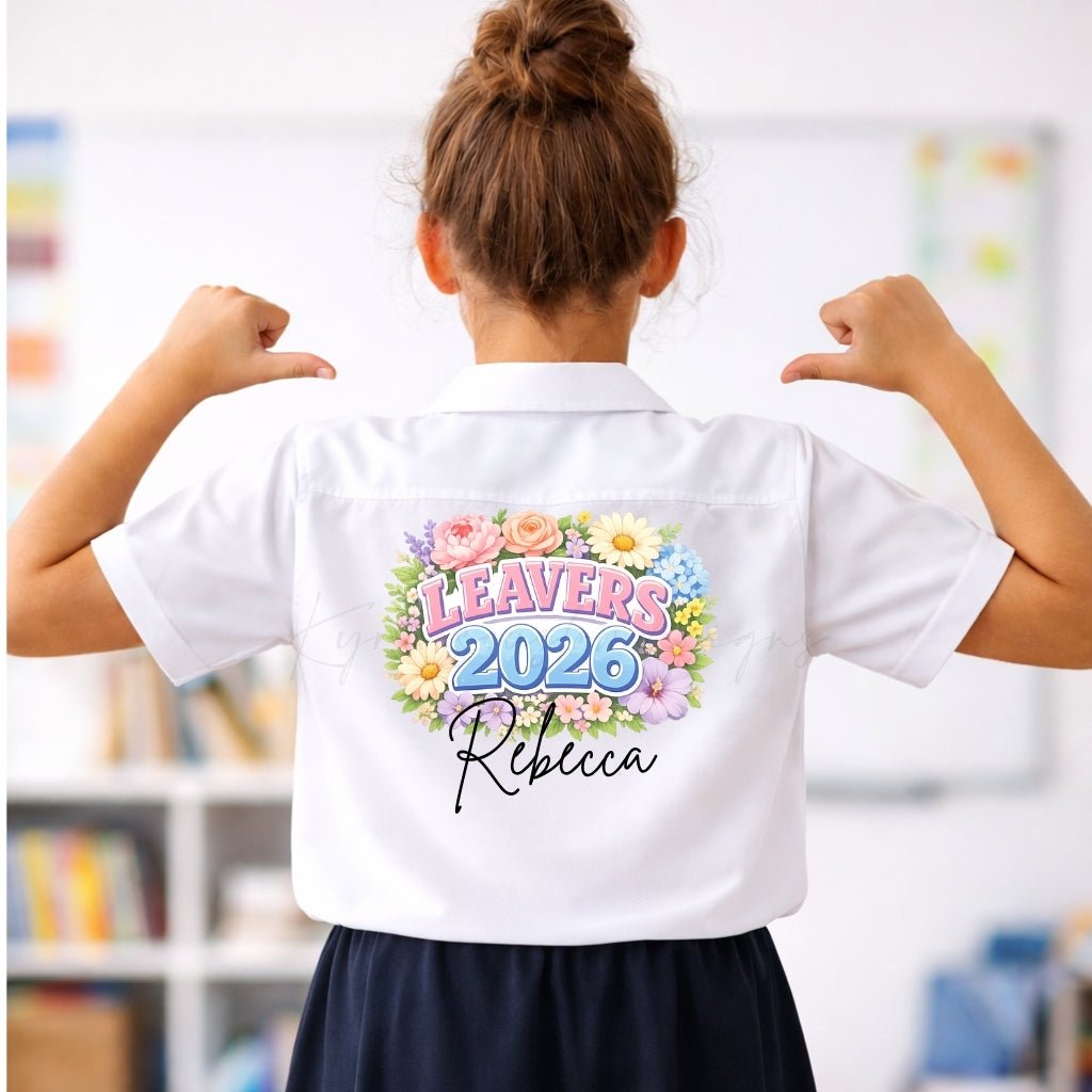Person wearing a white shirt with 'Leavers 2026' and 'Rebecca' printed on the back, in an indoor setting.