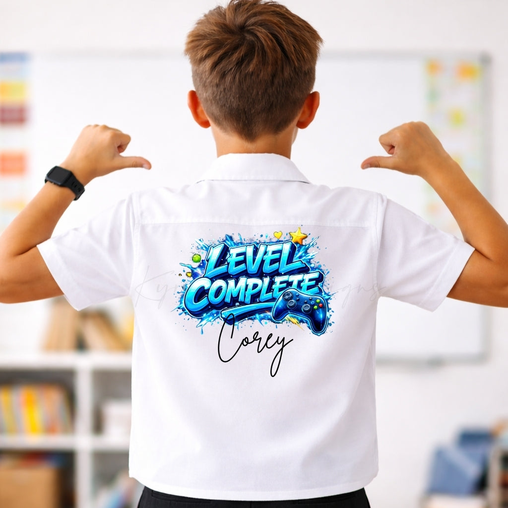 Person wearing a white shirt with 'Level Complete' design on the back, in an indoor setting.