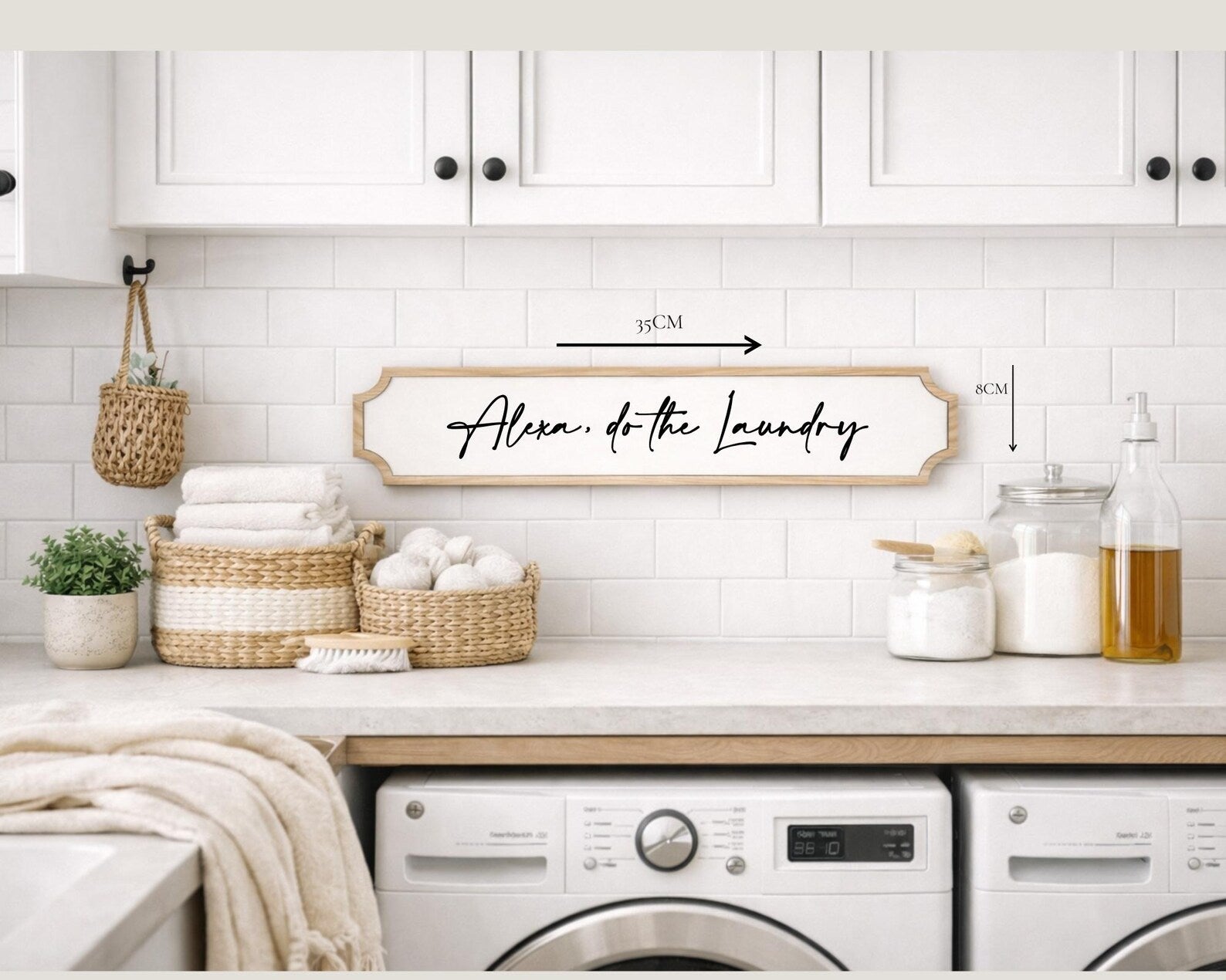 Laundry room with white cabinets, laundry basket, and 'Alexa, do the laundry' sign.